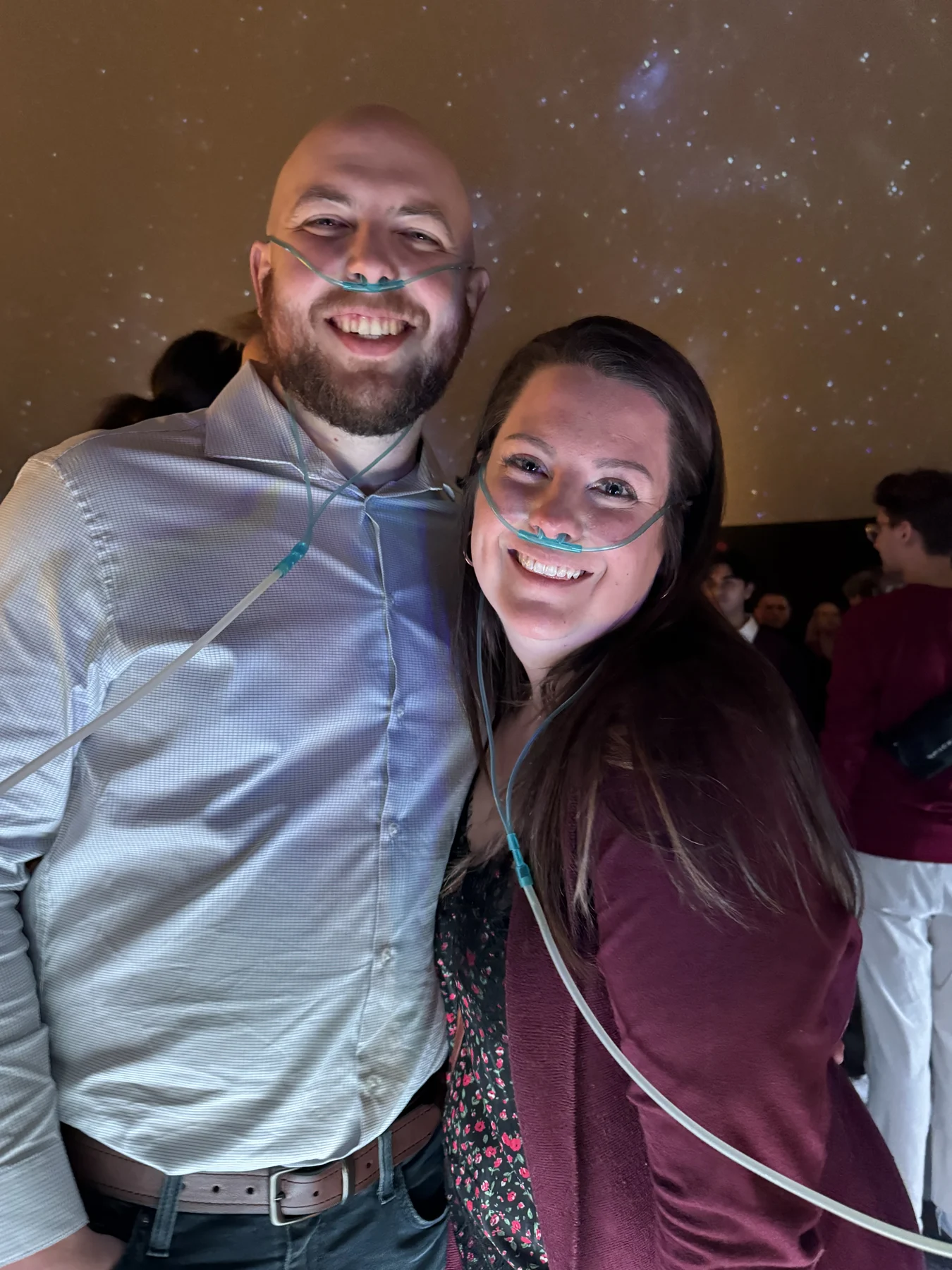 Two guests sharing a smile at an evening event