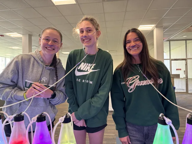 Three guests sharing the oxygen bar at a casual group event