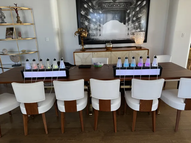 Two tabletop stations paired with white chairs in an elegant room
